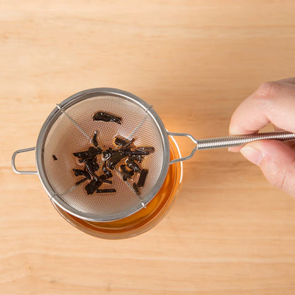 Loose tea leaves caught in the stainless steel strainer