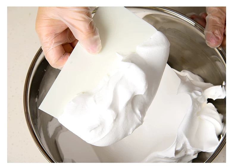 CakeLand bowl scraper lifting a whipped mixture from a mixing bowl