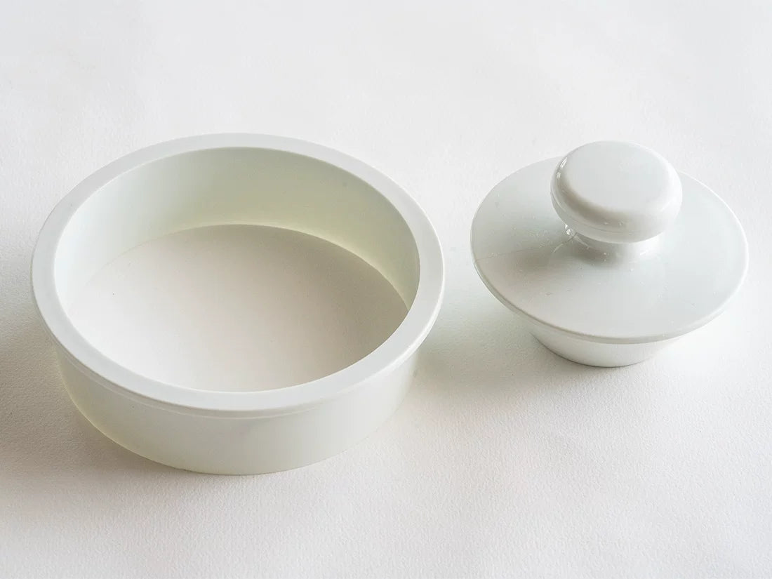 White pastry press and matching round dough cutter