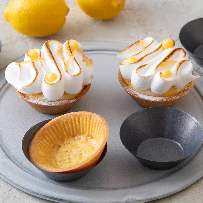 Individual lemon meringue tarts and pastry shells made with the nonstick tart cup