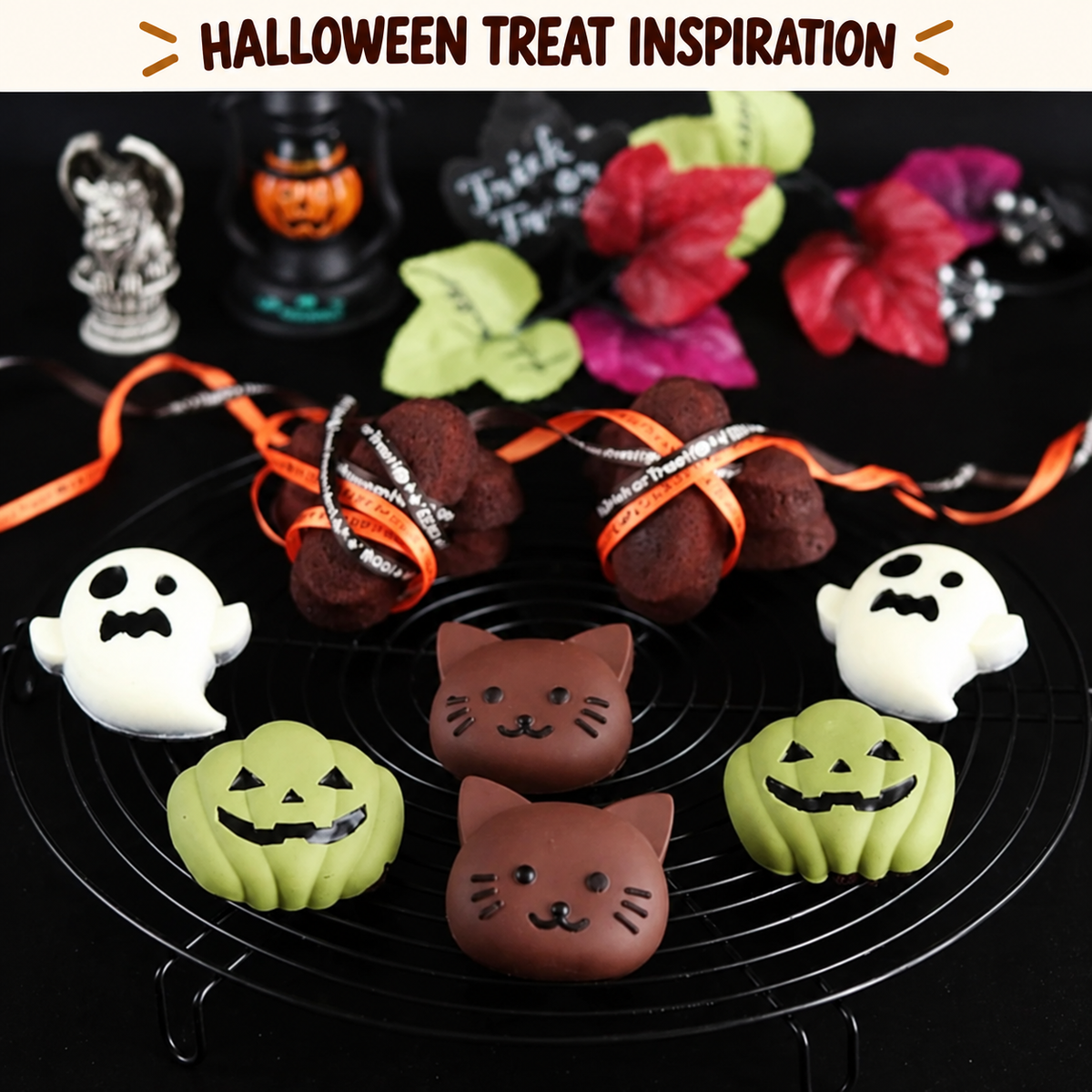 Halloween dessert inspiration with green pumpkin, white ghost and brown cat treats displayed on a black cooling rack.