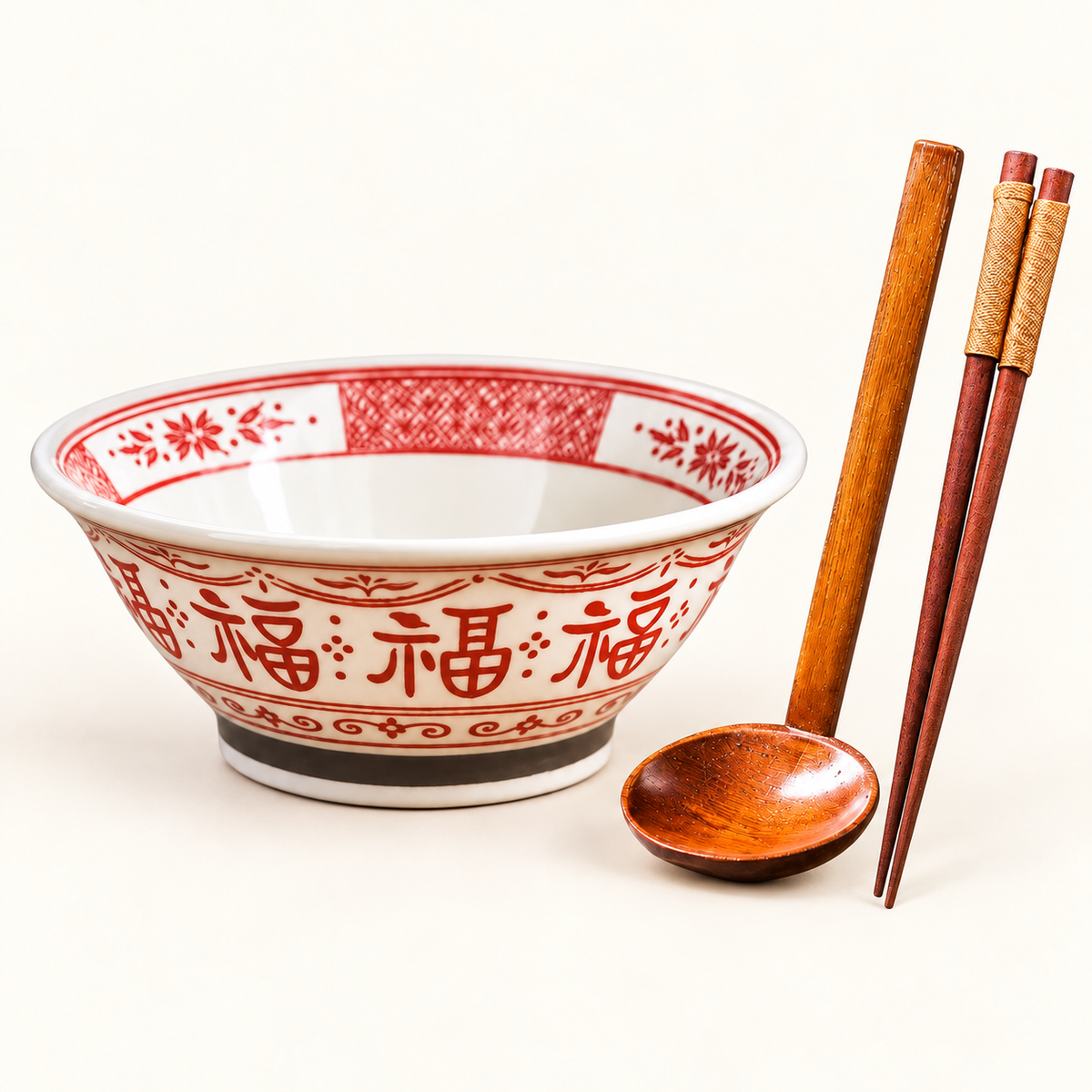Red 7-inch Good Fortune bowl with wooden spoon and chopsticks on ivory background