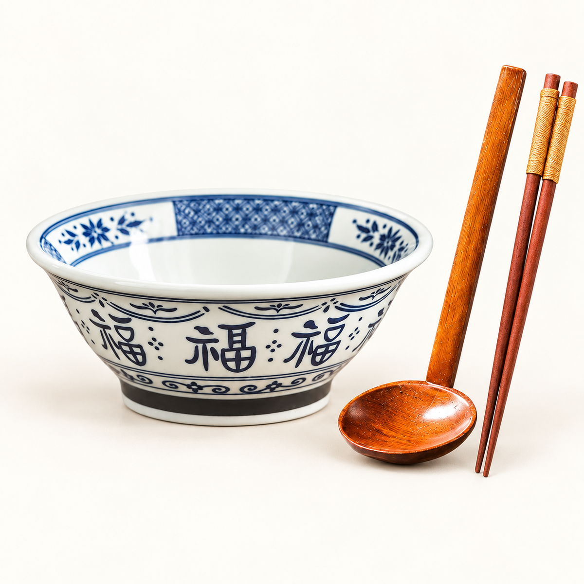 Blue 7-inch Good Fortune bowl with wooden spoon and chopsticks on ivory background