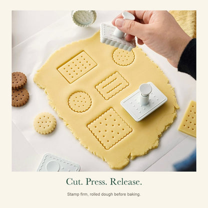 Press-down biscuit stamp and cutter in use on rolled dough, showing dotted and wavy patterns