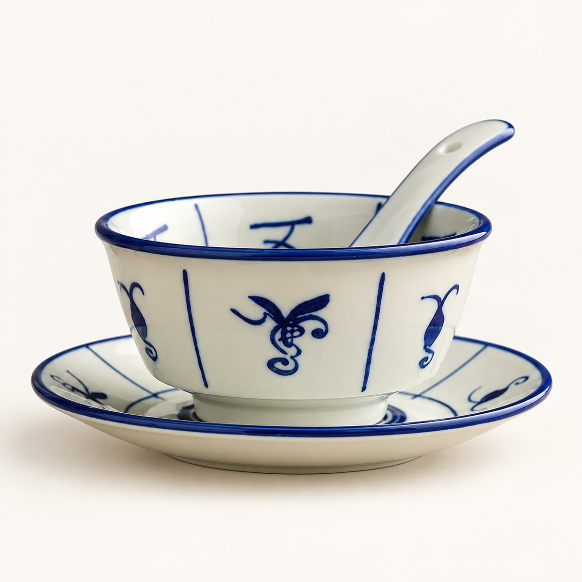 Blue Orchid ceramic bowl, plate and spoon on an ivory background