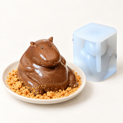 Capybara-shaped chocolate pudding on an ivory plate beside the translucent silicone mold; serving suggestion.