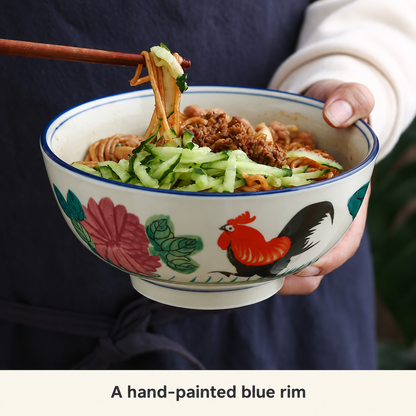 Rooster bowl filled with noodles, showing the blue rim